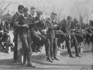 Dartmouth men carve their canes along the Senior Fence, c. 1910.